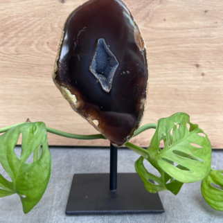 Agaat op standaard. Agaat werkt aardend, stabiliserend en beschermend. Het helpt jezelf accepteren en helpt vertrouwen hebben in jezelf.